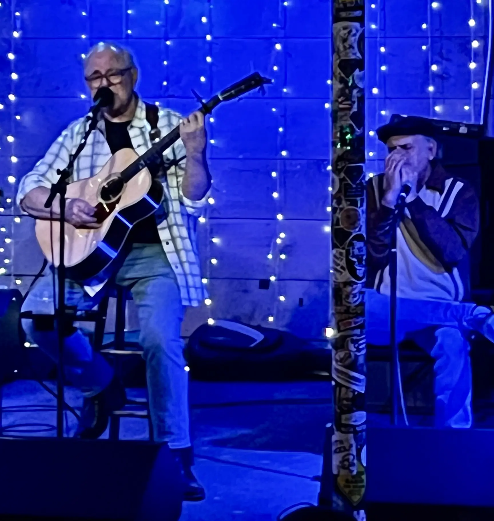 Dave Miller performing live with harmonica player, blue stage lights